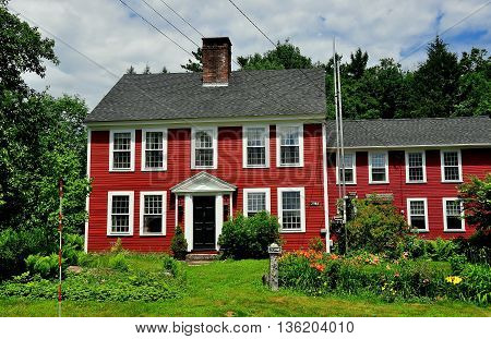 Jaffrey Center NH - July 11 2013: Classic New England c. 1784 wood frame colonial home with Summer garden