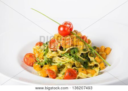 Italian homemade spinach and pumpkin pasta with tomatoes