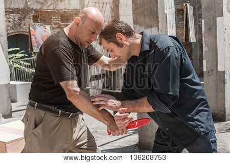 Kapap instructor demonstrates self defense techniques against a knife attack