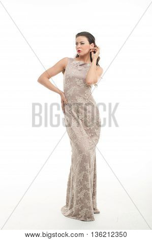 fashion model posing in studio, she wear evening dress