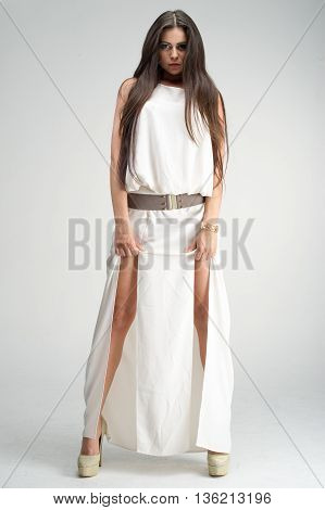 fashion model posing in studio, she wear evening dress