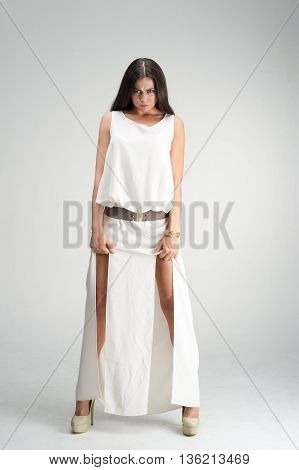 fashion model posing in studio, she wear evening dress