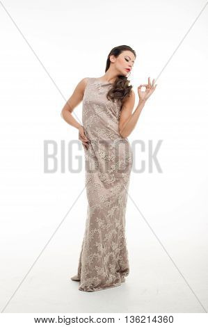 fashion model posing in studio, she wear evening dress