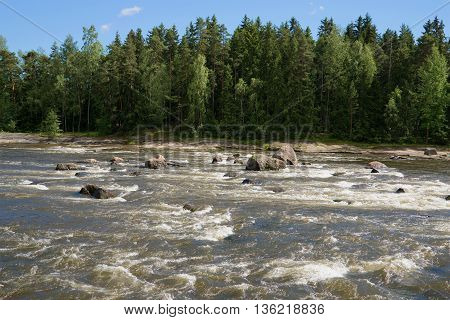 Sunny summer day on the river Kymiyoki. Langinkoski, Finland