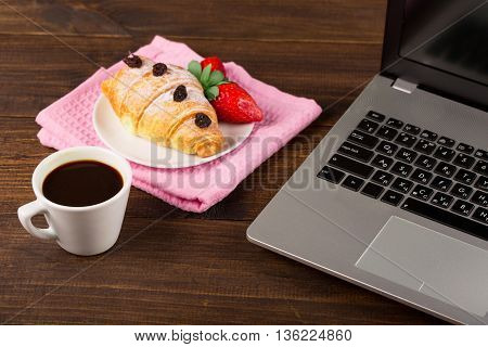 breakfast work with coffee and croissant. notebook