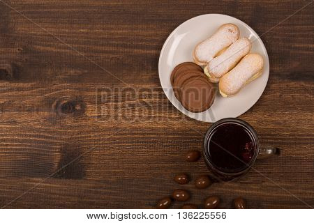 Cup of tea and cookies on the table. Wishing a nice day. Pleasant surprise a friend or loved one. . wooden table background. Top view