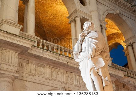 Night view of the statue of the famous renaissance architect Palladio and part of the Palladian basilica
