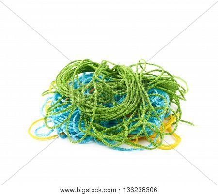 Mixed pile of colorful yarn threads isolated over the white background