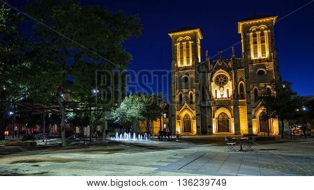 Water fountain and San Fernando Cathedral in San Antonio Texas at night