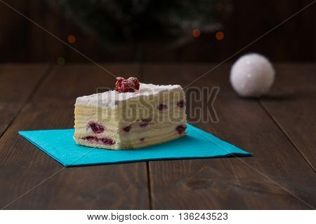 cake with fresh cherry on wooden background