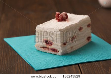 cake with fresh cherry on wooden background