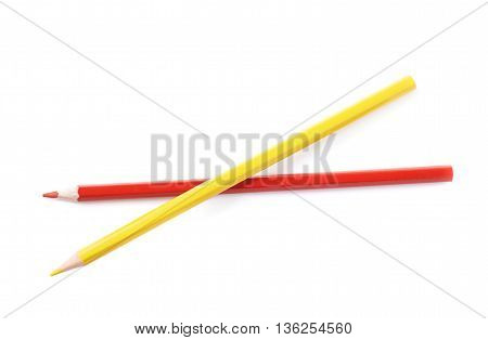 Two red and yellow colored drawing pencils composition isolated over the white background