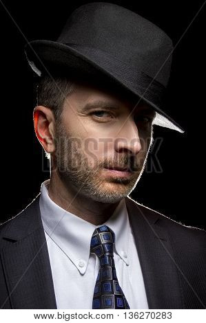 Man wearing a fedora hat as a film noir detective or gangster