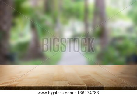 Selected focus empty brown wooden table and for product display montage big wooden table and garden.