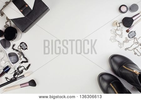 Women's accessories and cosmetics. Top view photo of colorful and glamour objects with free space for logo. There are shoes and perse