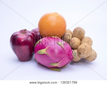 Mix colorful asian fruits of red apple dragon fruit orange and southern langsat on isolated / white background