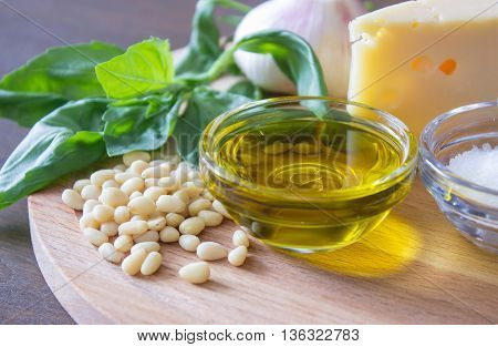 Sicilian basil pesto ingredients on wooden table. macro