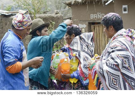 October 22 2012 Paru Paru Peru: Traditional Quechua Wedding Ceremony. Indigenous woman putting confetti on the bride`s mother hair.