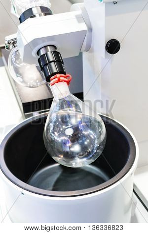 Round Glass Bulb Rotates In A Laboratory Evaporator.
