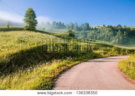 Colorful morning mist up the hills in the Romanian Apuseni Mountains near Salciua