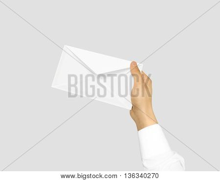 White blank envelope mock up holding in hand. Empty post document design mockup. Clear email display presentation in hands. Postcard template ready for your logo identity design. Closed, front layout.