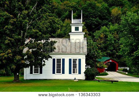 West Arlington Vermont - September 19 2014: The United Methodist Church on the Green and 1852 covered bridge over the Battenkill River