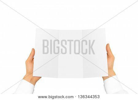 Hand in white shirt sleeve holding blank offset paper in the hand. Empty leaflet presentation. Booklet hand man. Man show brochure mock up. Menu in hands. Flyer design. Fold paper sheet display.