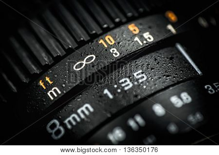 Professional DSLR lens on dark background. Macro photo.
