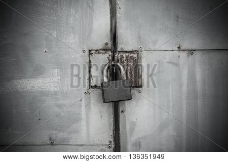 Old iron lock on the metal door (horror theme)
