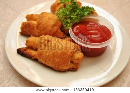 Fish Sticks Wrapped in Golden Croissant Rolls Served with Catsup
