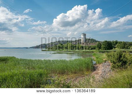 The bay of Slatbaken and Stegeborg Castle n Stegeborg during midsummer in Sweden. Stegeborg is a historic medieval royal castle.
