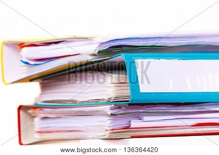 Paperwork. Stack of file folders ring binders on office table dask.