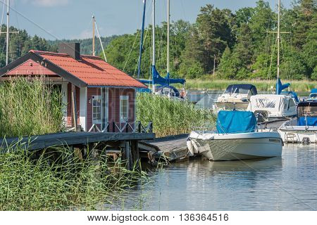STEGEBORG, SWEDEN - JUNE 25: Leisure boat marina in the bay of Slatbaken  in Stegeborg during midsummer in Sweden. Midsummer is one of the major holidays in Sweden.