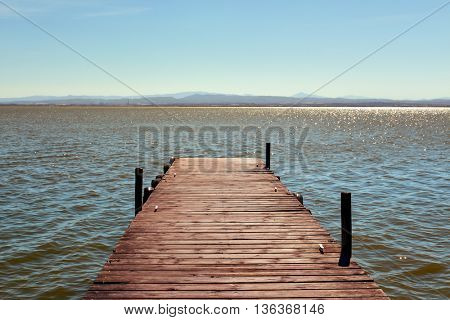 a wooden dock over the lagoon in the Albufera de Valencia, in Valencia, Spain