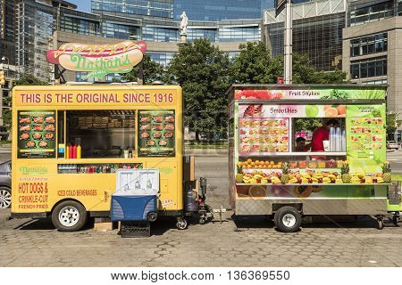 New York, USA - June 18, 2016: Hot dog and smoothie food trucks on Columbus Circle in New York City