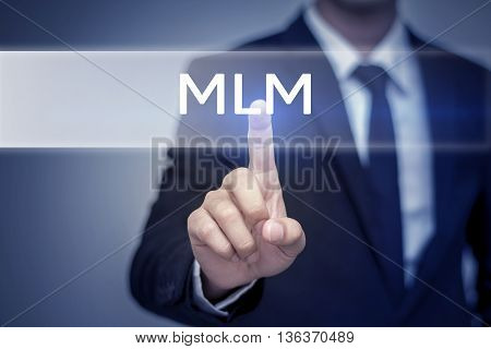 Businessman hand touching MLM button on virtual screen