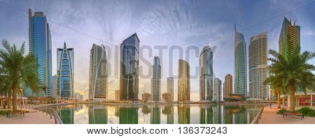 Panoramic view of Business bay and Lake Tower, reflection in a river, UAE.