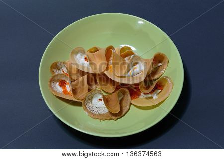 Front view of Thai Crispy Pancake ( Thailand is called Kanom Buang ) on a dish green and blue background dessert of Thailand