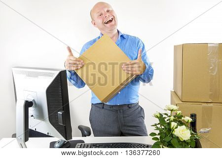 Happy man moves to a new office. First day at work.