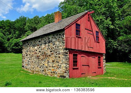 Chadds Ford Pennsylvania - June 9 2015: Fieldstone and wooden work shed at the Gideon Gilpin House in the historic Revolutionary War Brandywine Battlefield Historic Park *