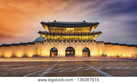 Gwanghwamun gate at Geyongbokgung Palace in Seoul at night. Long exposure image of traffic.