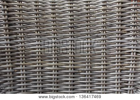 Rattan made from wood, Touching the surface of the tendon rattan, the brown wooden texture of rattan with natural patterns, gray rattan weave for closeup textured background