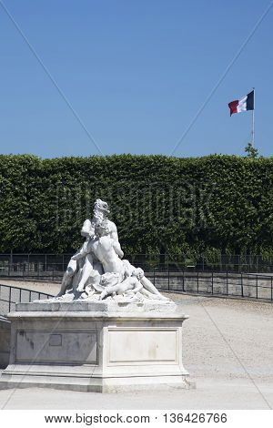 PARIS, FRANCE - JUNE 8, 2013:Sculptural composition in the Tuileries Garden in Paris on background French flag