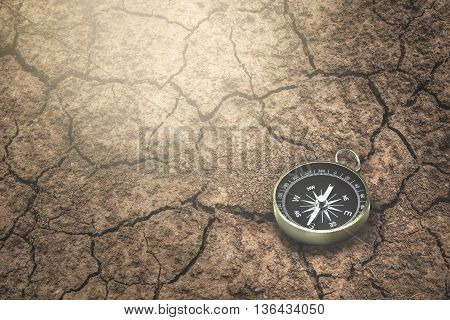 Compass on a the route dry cracked ground.