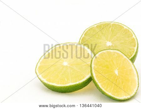 Three slices of lime on white background bottom right corner