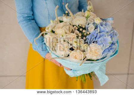 girl holding Bouquet of white and blue flowers