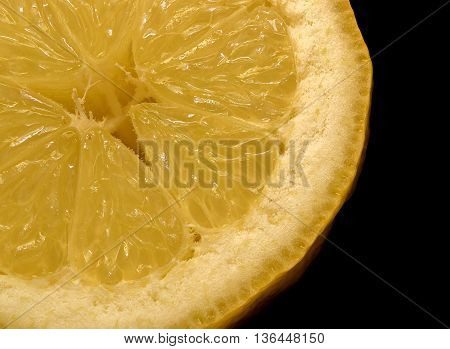A quarter lemon on black background macro