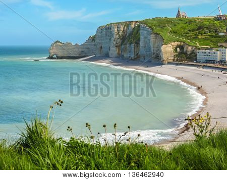 Footpaths on white rocks and view of the Etretat, France. Selective focus