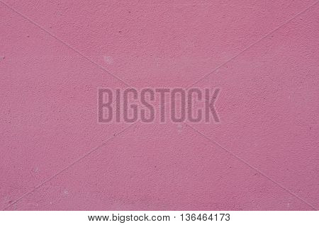 Background of a deep pink (rose-colored) painted wall