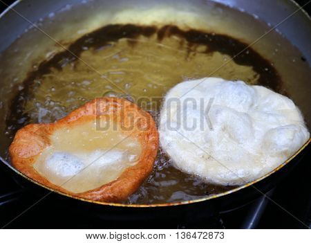 Two Italian Traditional Sweet Pastry Frying In Very Hot Oil